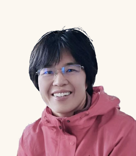 Juan Li, smiling, in a red field jacket